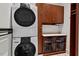 Well-equipped laundry room with stacked washer and dryer, wooden cabinets, and storage solutions at 102 Anna Lake Ln, Cary, NC 27513