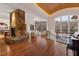 Open living space with a stone fireplace, water views, and hardwood floors for modern comfort at 102 Anna Lake Ln, Cary, NC 27513