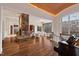 Open living space featuring a beautiful piano, stone fireplace, and scenic lake views at 102 Anna Lake Ln, Cary, NC 27513