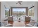 Bright living room featuring hardwood floors, a ceiling fan, and a scenic view of the lake at 102 Anna Lake Ln, Cary, NC 27513