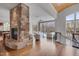Spacious living room featuring hardwood floors, a stone fireplace, and a scenic view of the lake at 102 Anna Lake Ln, Cary, NC 27513
