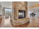 Spacious living room featuring a stone fireplace and hardwood floors at 102 Anna Lake Ln, Cary, NC 27513