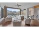 Bright living room featuring hardwood floors and a scenic view of the lake through large windows at 102 Anna Lake Ln, Cary, NC 27513