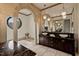 Elegant main bathroom featuring double vanities, soaking tub, and unique architectural details at 102 Anna Lake Ln, Cary, NC 27513