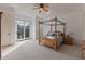 Bright main bedroom with four-poster bed, lake views, and large windows at 102 Anna Lake Ln, Cary, NC 27513