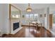 Bright office space features a fireplace, large desk, wood floors, and a window with a peaceful outdoor view at 102 Anna Lake Ln, Cary, NC 27513