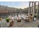 Outdoor patio featuring comfortable seating around a modern fire pit with serene lake views at 102 Anna Lake Ln, Cary, NC 27513