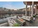 Inviting stone patio with outdoor seating and modern fire pit overlooking a scenic lake view at twilight at 102 Anna Lake Ln, Cary, NC 27513