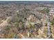 Aerial view of neighborhood featuring winding roads, mature trees, and diverse home styles at 106 Ferris Wheel Ct, Cary, NC 27513
