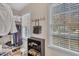 Walk-in closet featuring two windows, closet system and hanging bag on hooks at 106 Ferris Wheel Ct, Cary, NC 27513