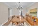 Dining room features wood flooring, traditional chandelier, table with seating for six at 106 Ferris Wheel Ct, Cary, NC 27513