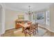 Traditional dining room with hardwood floors, decorative rug, chandelier, and built-in buffet at 106 Ferris Wheel Ct, Cary, NC 27513