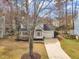 Exterior aerial view of home with a long driveway, front porch, and mature trees at 106 Ferris Wheel Ct, Cary, NC 27513