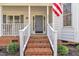 Inviting front porch featuring brick steps, rocking chairs, and a charming entrance at 106 Ferris Wheel Ct, Cary, NC 27513