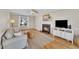 Bright living room featuring a fireplace, comfortable seating, and hardwood floors at 106 Ferris Wheel Ct, Cary, NC 27513