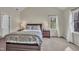 Main bedroom featuring vaulted ceiling, soft carpet and a large window with natural light at 106 Ferris Wheel Ct, Cary, NC 27513