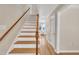 Elegant staircase with hardwood steps and a decorative railing at 106 Ferris Wheel Ct, Cary, NC 27513