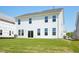 View of a white two-story home with a green lawn and sliding glass doors at 106 Willow Cameron Way, Angier, NC 27501