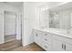 Bright bathroom featuring double sinks, a walk-in closet, and a glass shower at 106 Willow Cameron Way, Angier, NC 27501