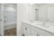 Elegant bathroom with dual sinks, quartz countertops, and modern wood-look flooring at 106 Willow Cameron Way, Angier, NC 27501