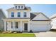 Charming new construction two-story home featuring a covered entryway and attached two car garage at 106 Willow Cameron Way, Angier, NC 27501