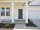 Inviting covered front porch with white columns and a black front door at 106 Willow Cameron Way, Angier, NC 27501