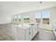 Open floor plan with kitchen island featuring stainless steel dishwasher and sink, and hardwood flooring throughout at 106 Willow Cameron Way, Angier, NC 27501