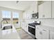 Close up of well-equipped kitchen featuring white cabinets, stainless appliances, subway tile backsplash, and granite countertops at 106 Willow Cameron Way, Angier, NC 27501