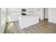 Modern white kitchen featuring an island with seating and stainless steel appliances at 106 Willow Cameron Way, Angier, NC 27501