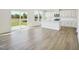 Open-concept living space featuring light wood floors, a modern kitchen and lots of natural light at 106 Willow Cameron Way, Angier, NC 27501
