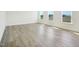 Bright and airy living room with light wood flooring and three large windows at 106 Willow Cameron Way, Angier, NC 27501