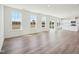 Open-concept living space with light wood floors, large windows, and views into the modern white kitchen at 106 Willow Cameron Way, Angier, NC 27501