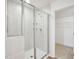 Clean shower stall with clear glass and shelving next to a closet provides a spa-like bathroom at 106 Willow Cameron Way, Angier, NC 27501