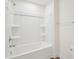 Pristine white shower and tub combination with sleek fixtures and built-in shelving at 106 Willow Cameron Way, Angier, NC 27501
