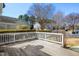 Wooden deck with a white railing overlooking a fenced backyard, with homes in background at 10617 Catara Dr, Raleigh, NC 27614