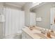 Traditional-style bathroom featuring a shower with white shower curtain, vanity and white fixtures at 10617 Catara Dr, Raleigh, NC 27614