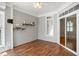 Cozy sunroom features hardwood floors, wood paneled walls, bright windows, and a sliding glass door at 10617 Catara Dr, Raleigh, NC 27614