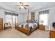 Spacious main bedroom with a tray ceiling, four-poster bed, and soft, neutral tones at 108 Galsworthy St, Cary, NC 27518