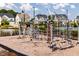 Community playground with climbing structure and bench seating surrounded by charming homes and clear blue skies at 113 Cloud Berry Ln, Holly Springs, NC 27540