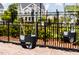 Outdoor playground equipment showing hanging swings with a black metal fence surrounding the area at 113 Cloud Berry Ln, Holly Springs, NC 27540