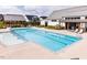 A community pool featuring a bright blue, inviting swimming area and meticulously landscaped areas at 113 Cloud Berry Ln, Holly Springs, NC 27540