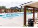 A community pool featuring a bright blue, inviting swimming area and shaded lounge area at 113 Cloud Berry Ln, Holly Springs, NC 27540