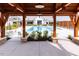 View of a pristine community swimming pool, seen from under a wooden pergola. Chairs are available for lounging at 113 Cloud Berry Ln, Holly Springs, NC 27540