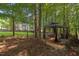 View of backyard featuring wooded lot, lawn, picket fence and outdoor gazebo with seating at 116 Wright Hill Dr, Durham, NC 27712