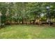 Expansive backyard featuring lush greenery, a gazebo, and ample space for recreation at 116 Wright Hill Dr, Durham, NC 27712