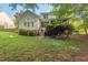 Back exterior of a home with a screened in porch and outdoor steps into the yard at 116 Wright Hill Dr, Durham, NC 27712