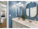 Bathroom features double sinks, two oval mirrors, blue walls and hardwood floors at 116 Wright Hill Dr, Durham, NC 27712