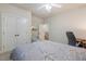 Cozy bedroom featuring a ceiling fan, double door closet and wood desk area at 116 Wright Hill Dr, Durham, NC 27712
