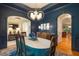 Elegant dining room with navy walls, hardwood floors, and designer lighting at 116 Wright Hill Dr, Durham, NC 27712