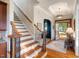 Inviting home foyer featuring hardwood floors, staircase, and stylish decor at 116 Wright Hill Dr, Durham, NC 27712